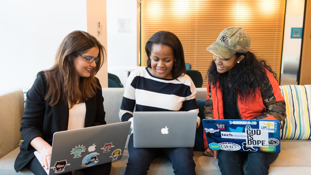 a trio of women on their laptops
