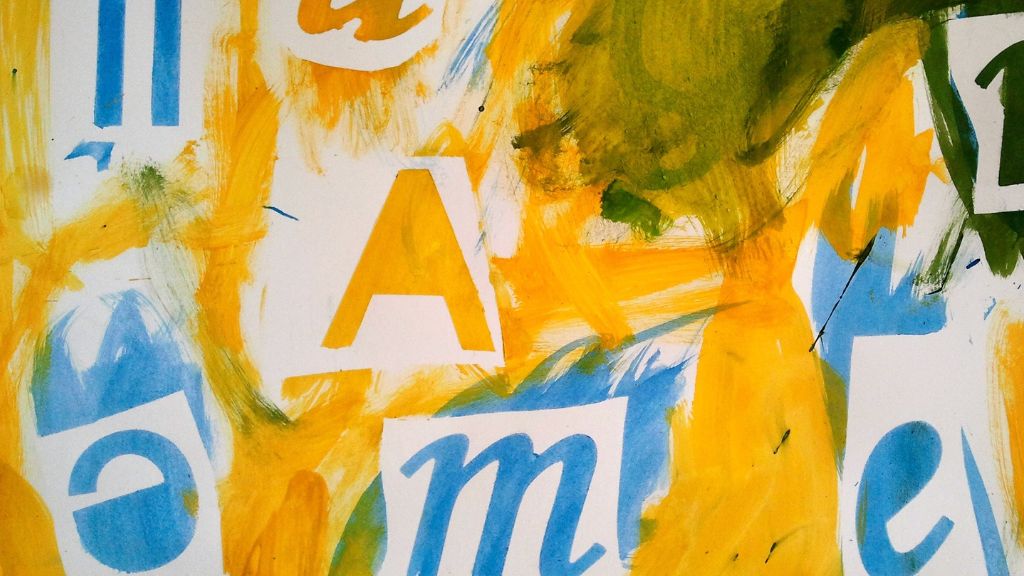 bright painting of letters in yellow, blue and green